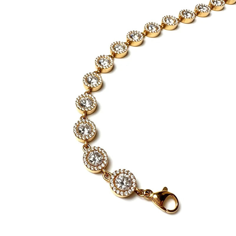 Gold halo tennis bracelet with hand-set stones