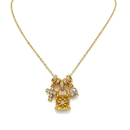 Gold charm necklace with lock, ring and cross pendants