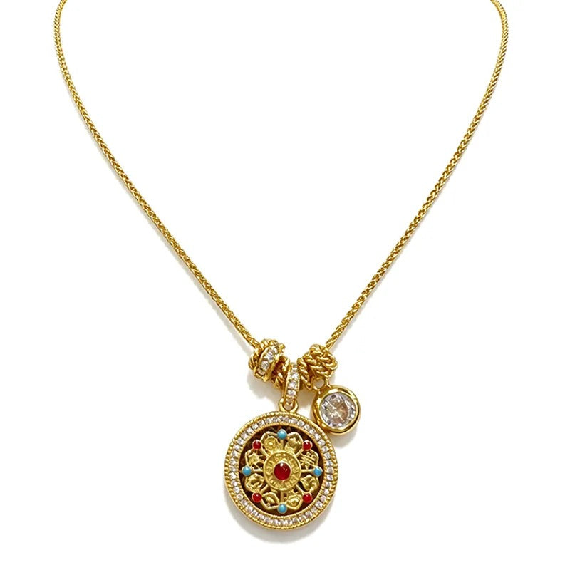 Gold medallion necklace with a red enamel centre